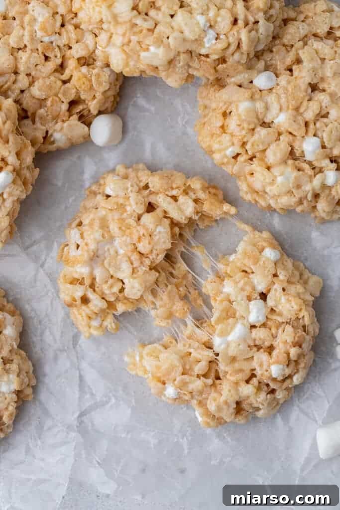 A stack of gooey, marshmallow-rich Rice Krispies cookies, highlighting their soft and chewy interior.