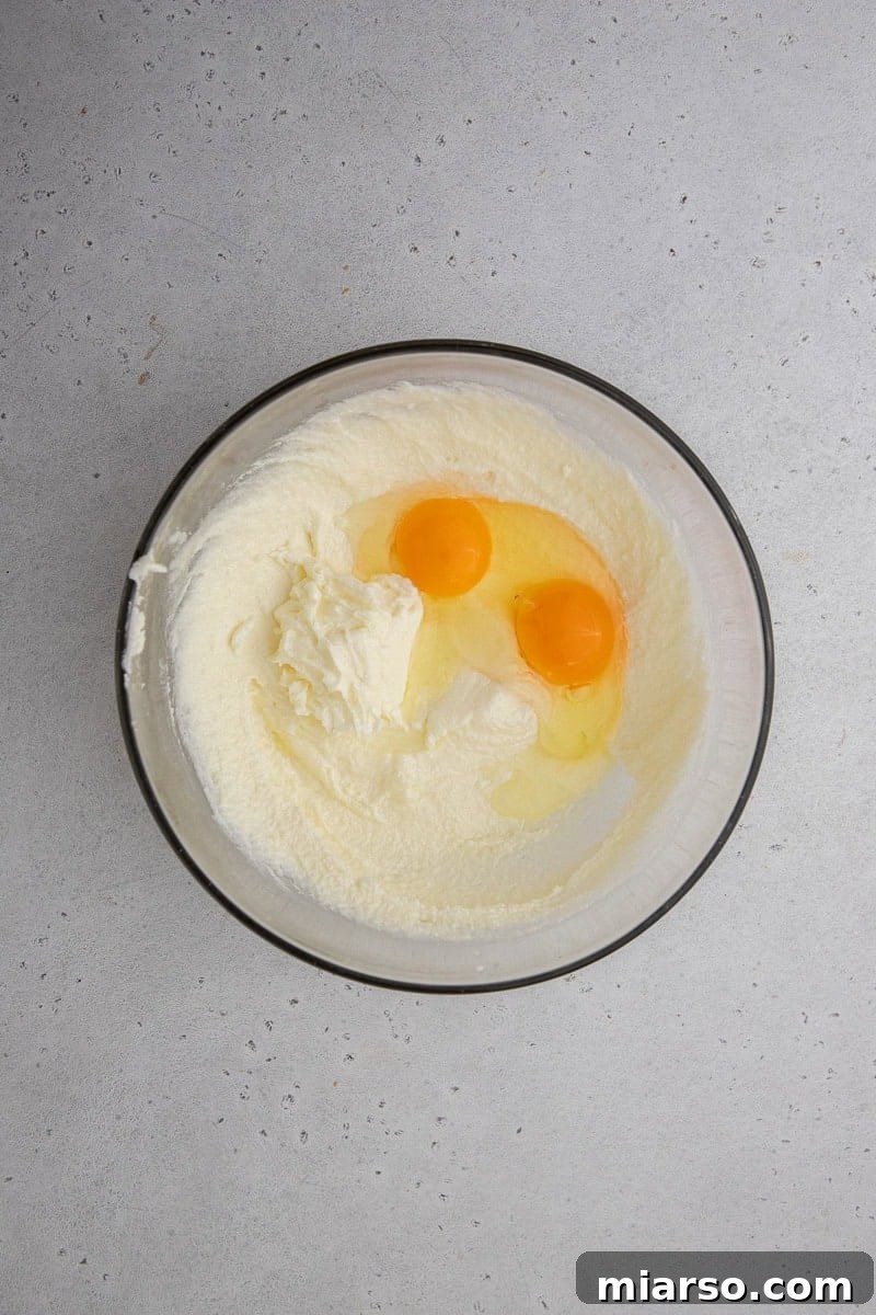 Wet ingredients being mixed in a bowl, showing the creamy texture of butter and sugar.