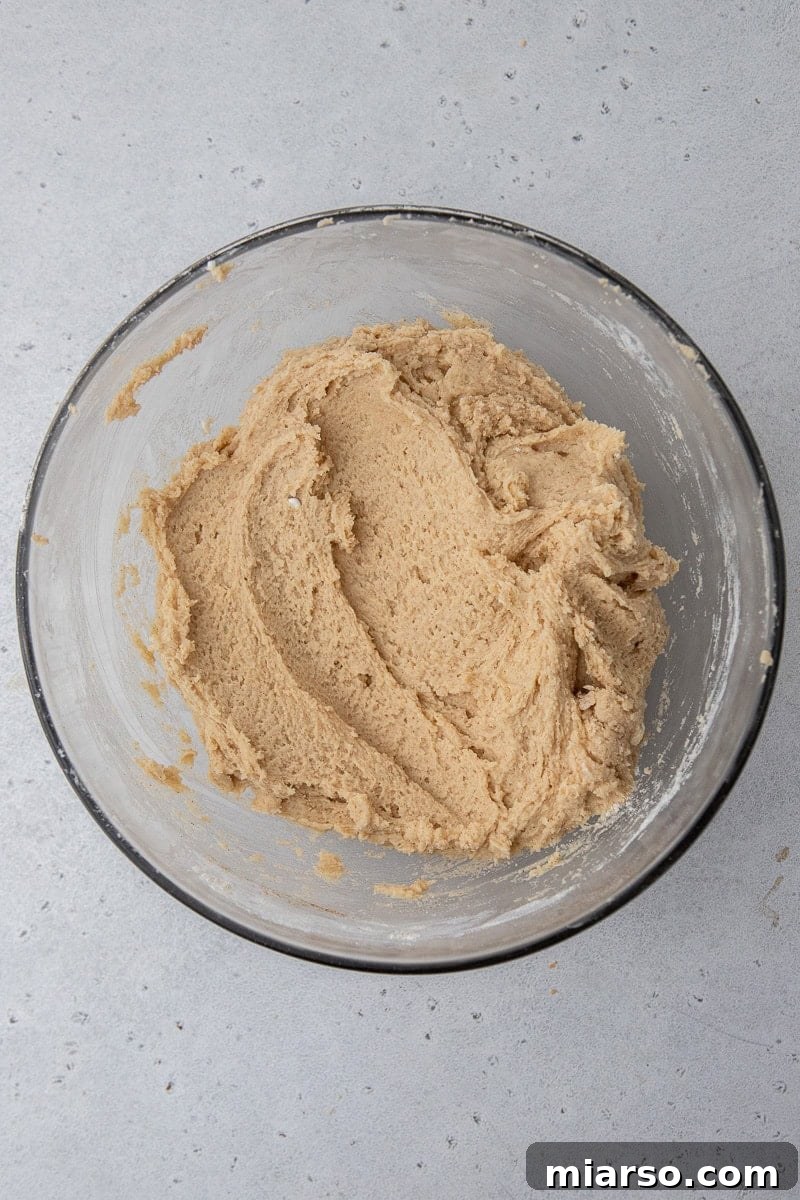 Cookie dough in a mixing bowl, ready to be transferred to the skillet.