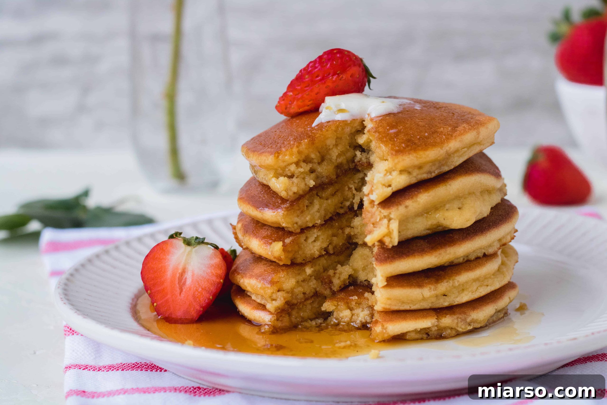 Ultimate Fluffy Almond Flour Pancakes 8 Almond flour paleo pancakes on a white plate