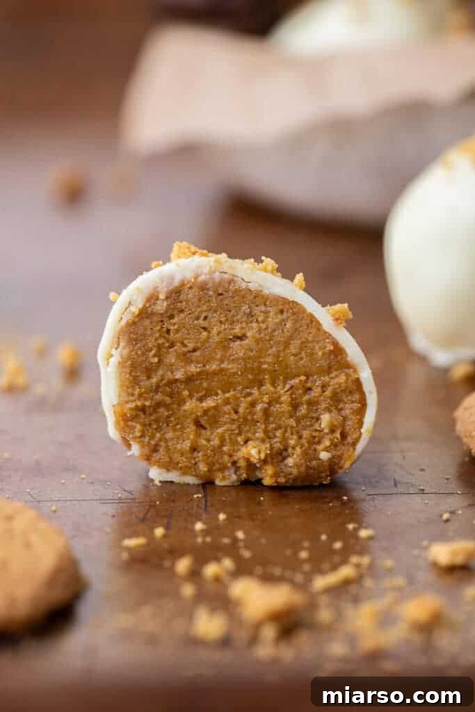 Divine Chocolate Pumpkin Truffle Delights 10 Pumpkin pie truffle cut in half, showcasing the creamy interior
