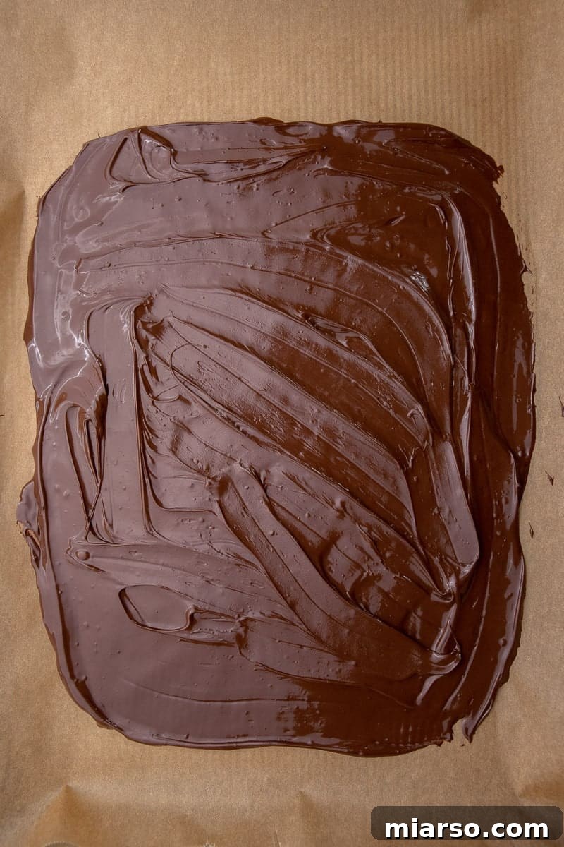 Decadent Salted Caramel Pretzel Bark 5 Melted chocolate on baking sheet