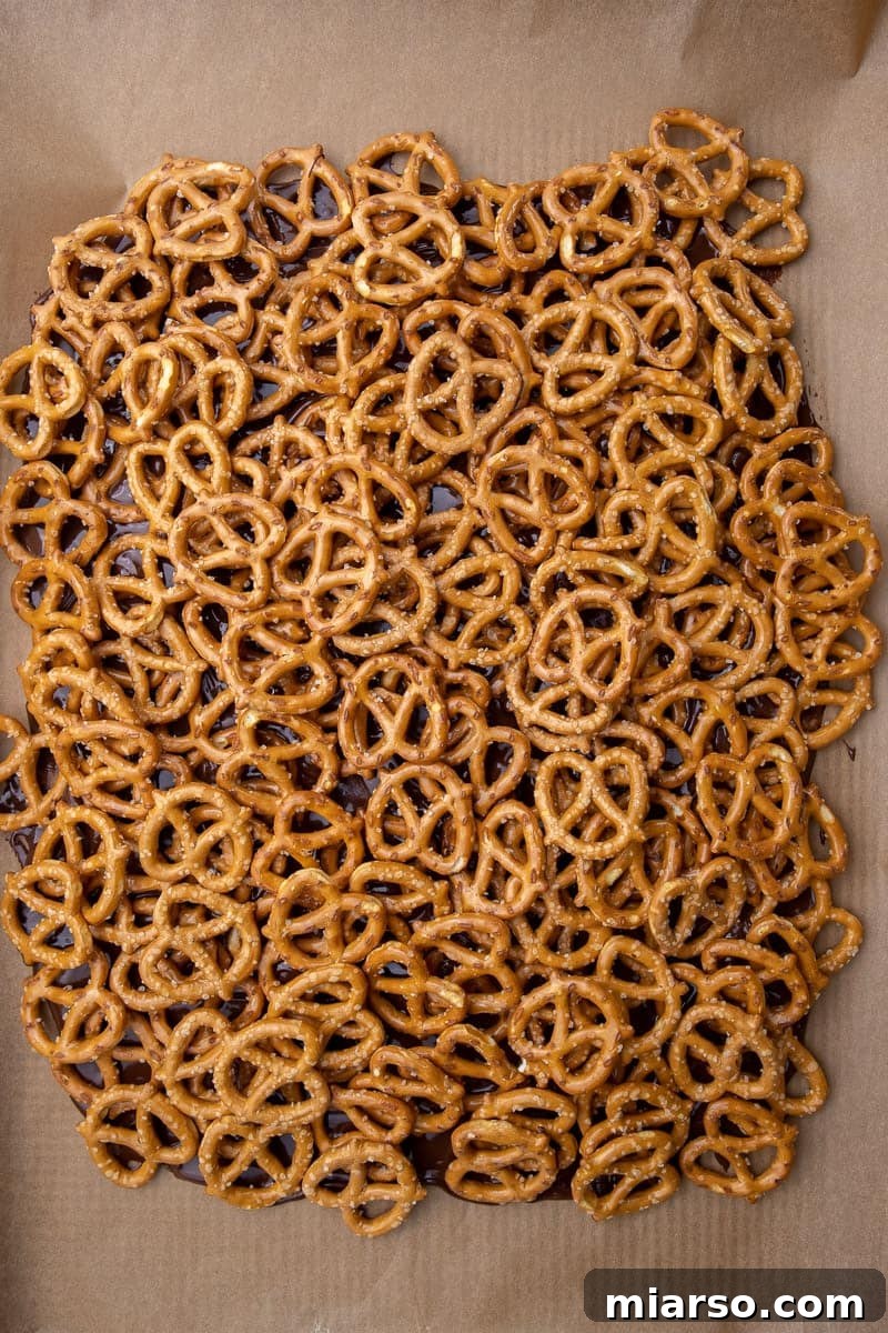 Decadent Salted Caramel Pretzel Bark 6 Pretzel on melted chocolate