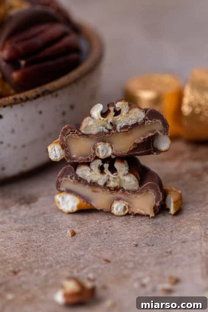 Close-up of Rolo Pretzel Turtles cooling on a baking sheet, showcasing the melted Rolo and pecan.