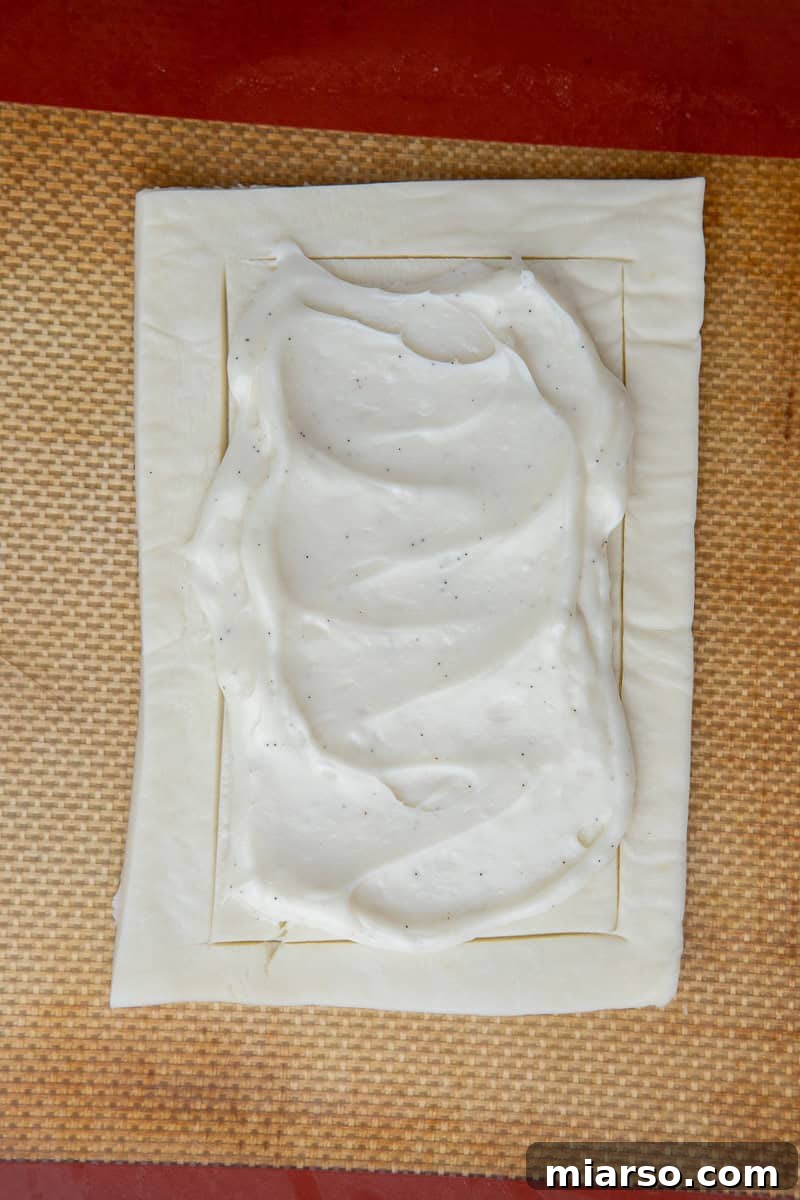 Cranberry Cheese Danish Revival 8 Cream cheese filling spread onto puff pastry rectangles, within the scored borders.