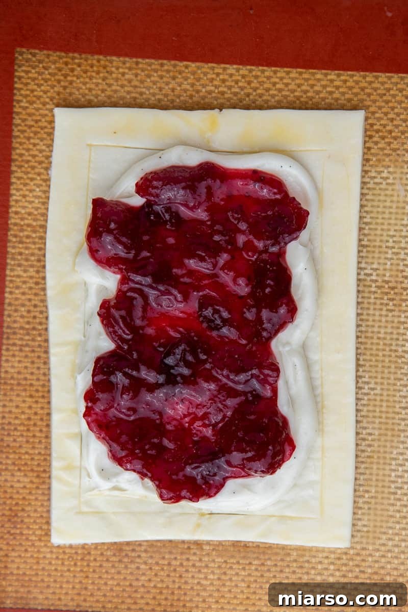 Cranberry Cheese Danish Revival 9 Vibrant cranberry sauce spooned over the cream cheese filling on the pastry.