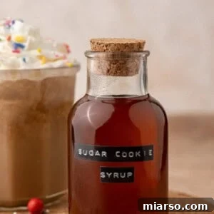 Sugar cookie syrup in a container, ready to be used in festive drinks.