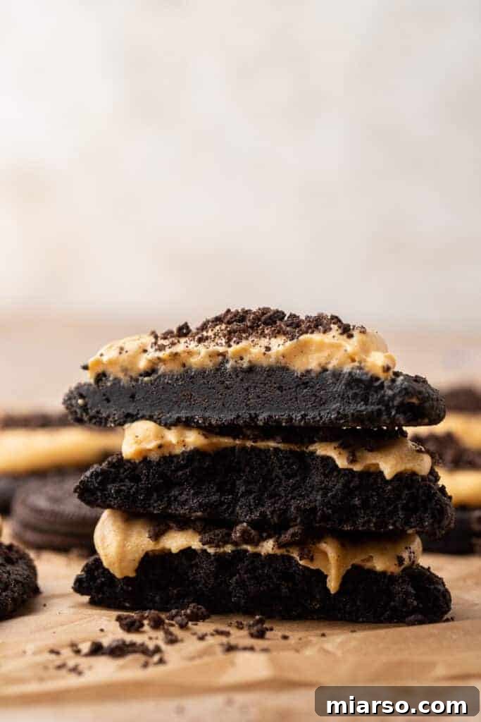 Decadent Crumbl Chocolate Pumpkin Cheesecake Cookies 2 Decadent Crumbl-inspired chocolate pumpkin cheesecake cookies with creamy orange frosting and Oreo crumbles