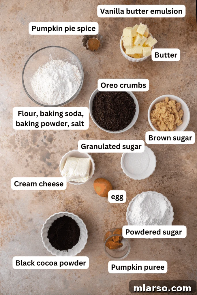 Decadent Crumbl Chocolate Pumpkin Cheesecake Cookies 3 Key baking ingredients for chocolate pumpkin cheesecake cookies laid out on a kitchen countertop