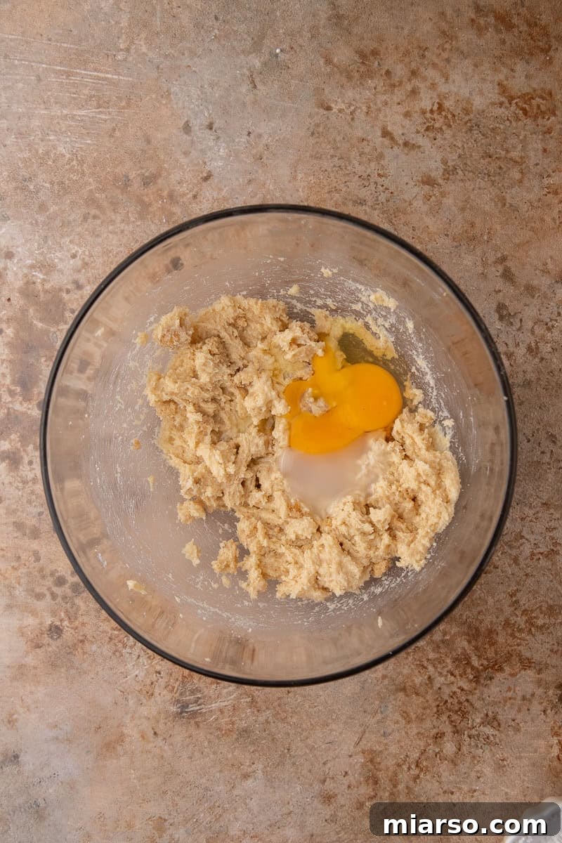 Decadent Crumbl Chocolate Pumpkin Cheesecake Cookies 5 Mixing wet ingredients for cookies in a bowl