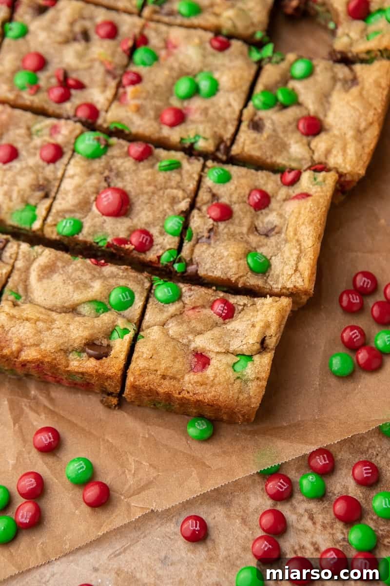 Irresistible Holiday M&M's Blondies 9 Close-up of freshly baked and sliced Christmas blondies, showing the festive M&M's