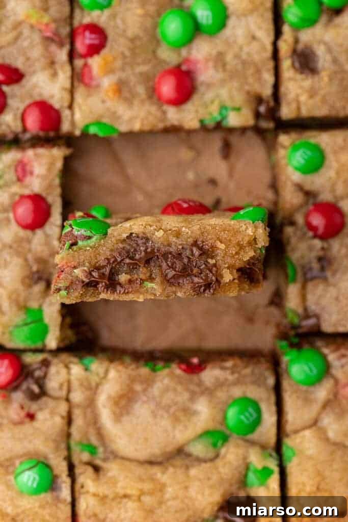 Irresistible Holiday M&M's Blondies 10 A plate of perfectly sliced blondies, highlighting the festive M&M's throughout