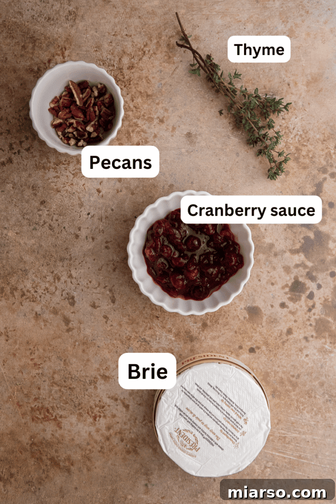 Fresh Ingredients for Baked Brie including Cheese, Cranberry Sauce, Nuts, and Thyme