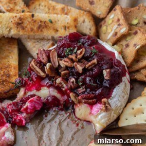 Baked Brie with cranberry sauce, nuts, and thyme