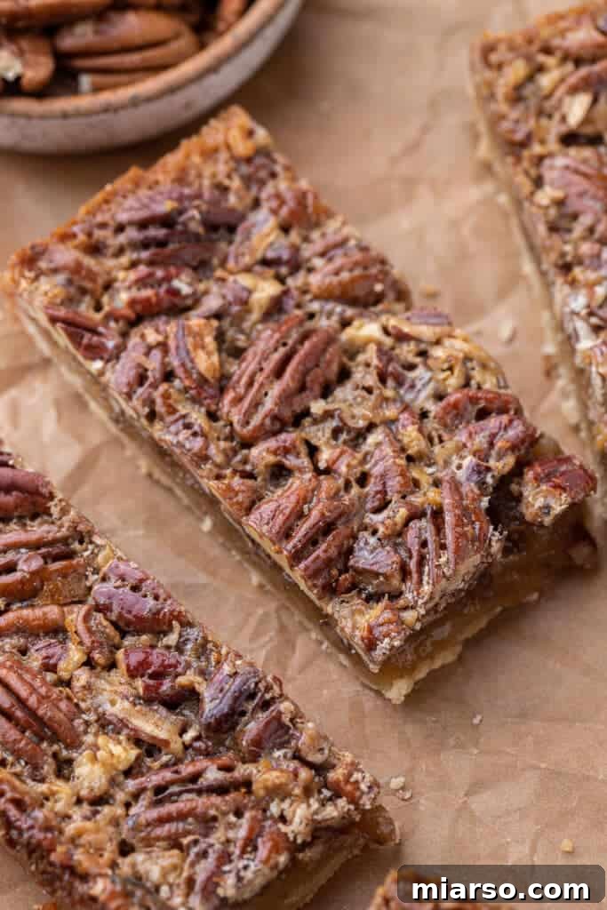 A large tray of freshly baked and sliced pecan pie bars.