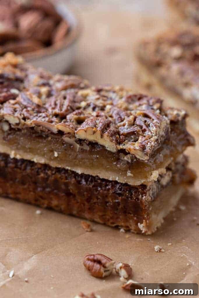 Easy pecan pie bars presented artfully on a serving dish.