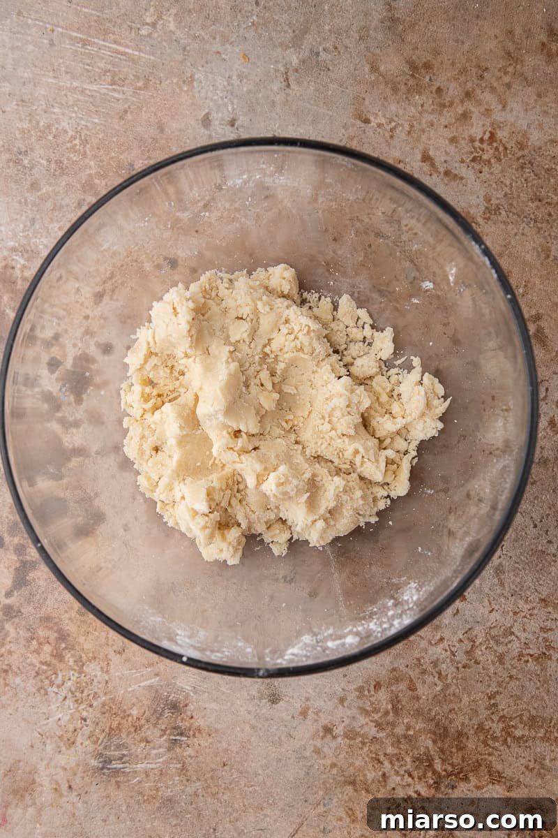 Shortbread dough mixture in a mixing bowl, ready to be pressed into the pan.