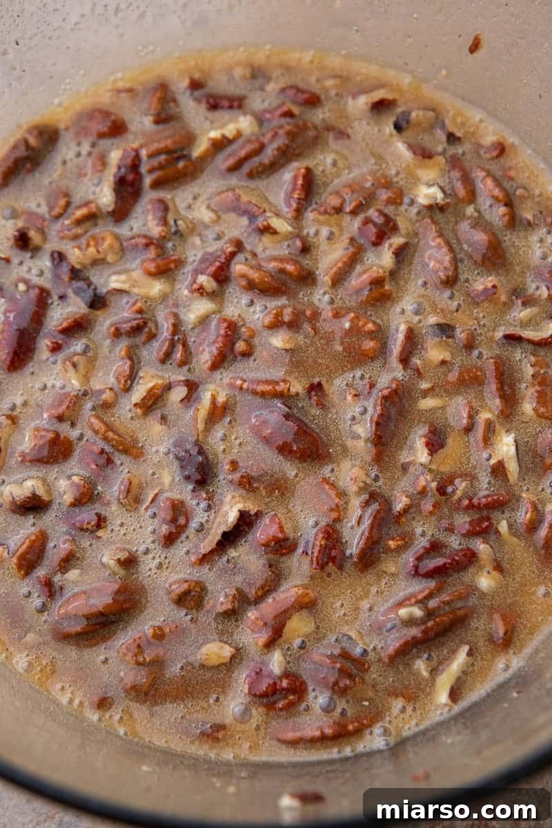 Chopped pecans added to the rich pecan pie filling mixture.
