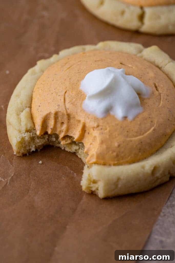 Pumpkin Pie Perfection Crumbl Style 2 Close up of Crumbl pumpkin pie cookie with a bite taken out of it