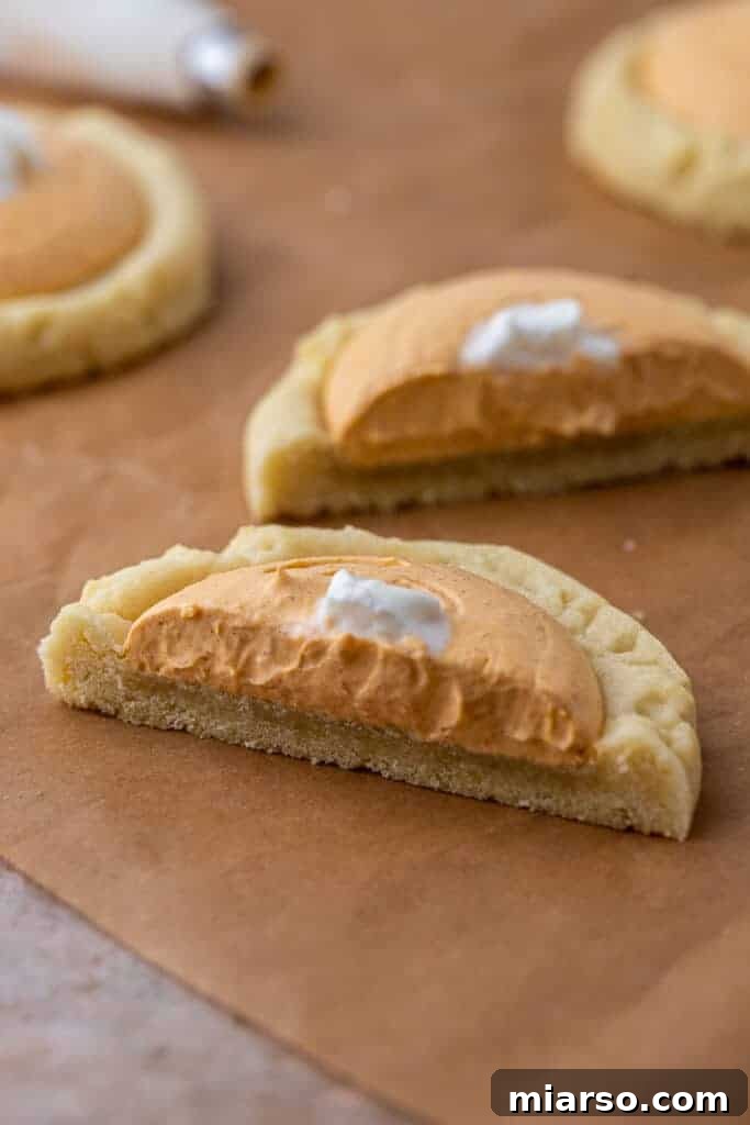 Pumpkin Pie Perfection Crumbl Style 4 Pumpkin cookie sliced in half with creamy filling