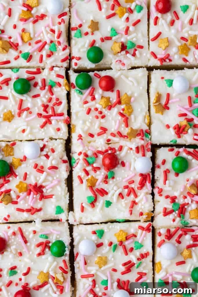 Overhead shot of cookie bar frosting being spread with a spatula