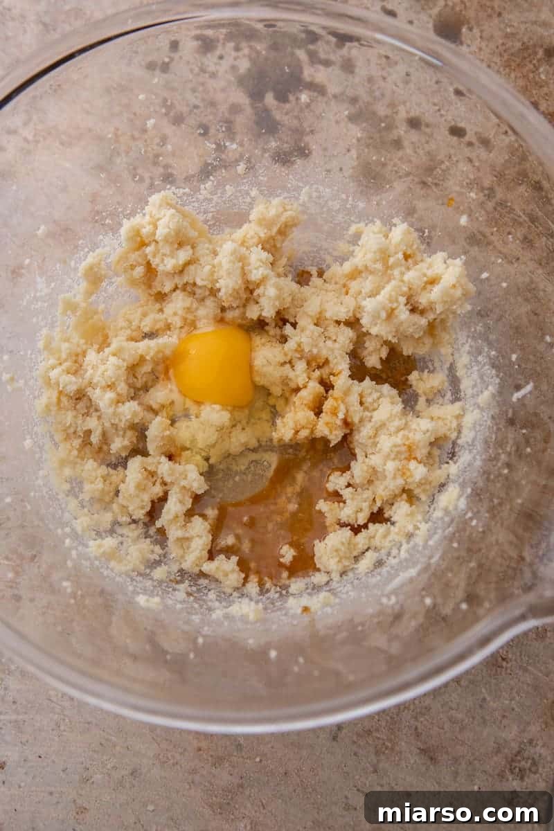 Wet ingredients (butter, sugar, egg, extracts) in a mixing bowl
