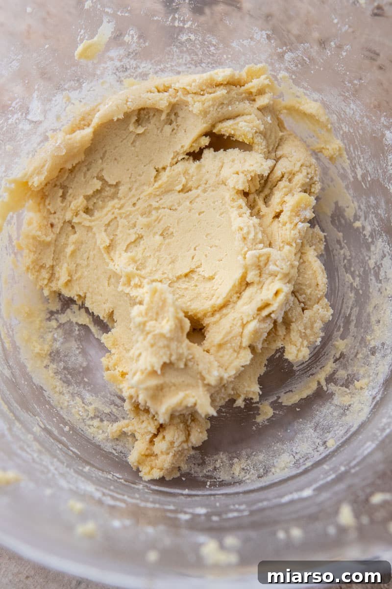 Cookie dough mixture in a mixing bowl before spreading