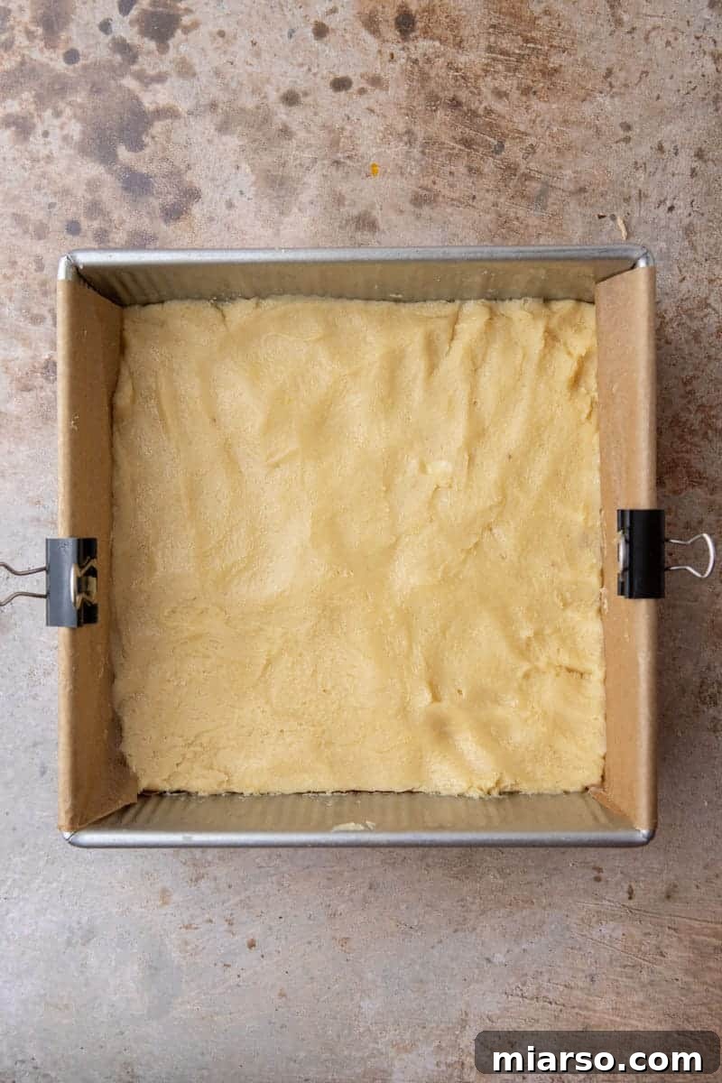 Sugar cookie dough evenly spread in a baking pan