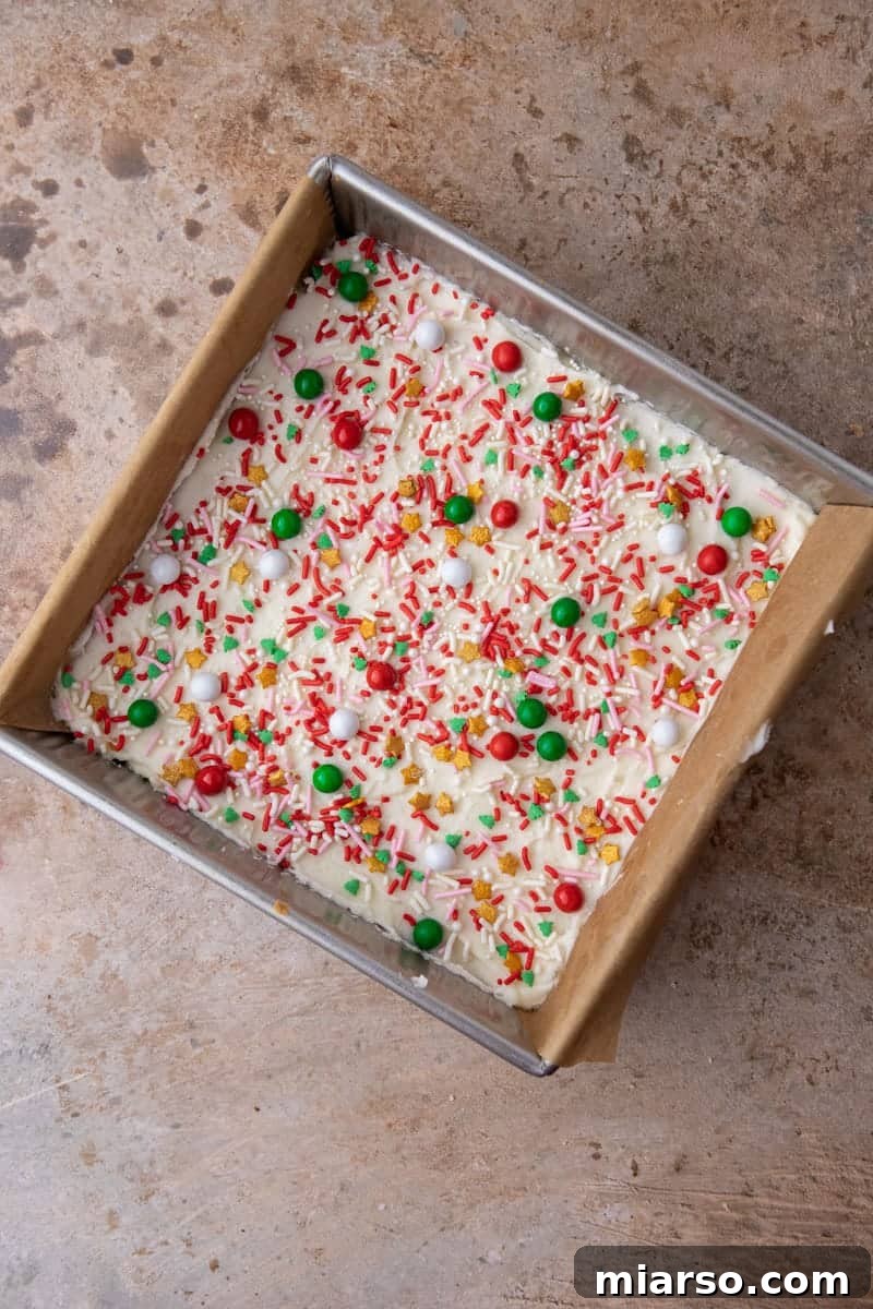 Frosted sugar cookies in a pan, ready to be cut