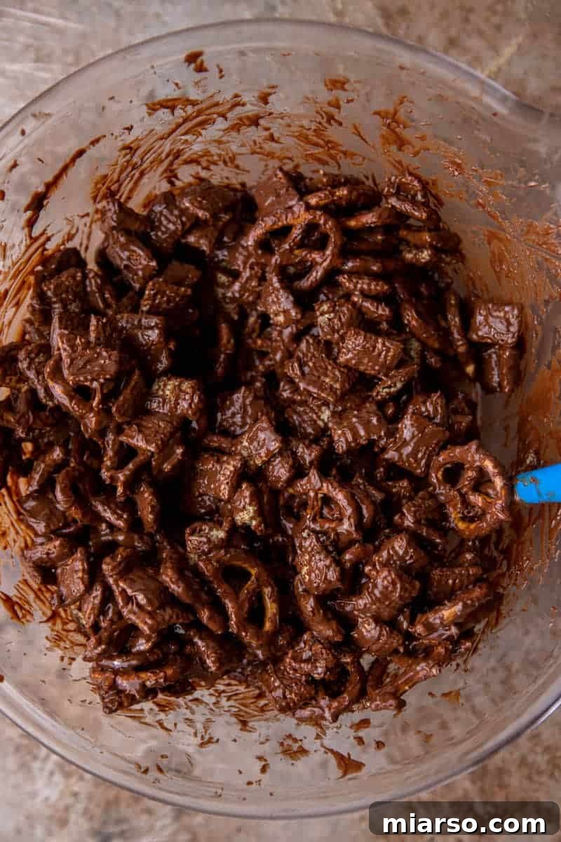 Chex cereal being added to a bowl with melted chocolate