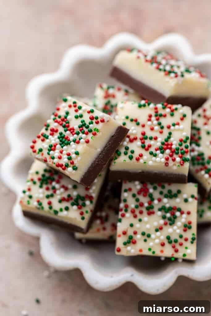 Holiday Showstopper Layered Fudge 11 Close up of Christmas fudge squares with sprinkles