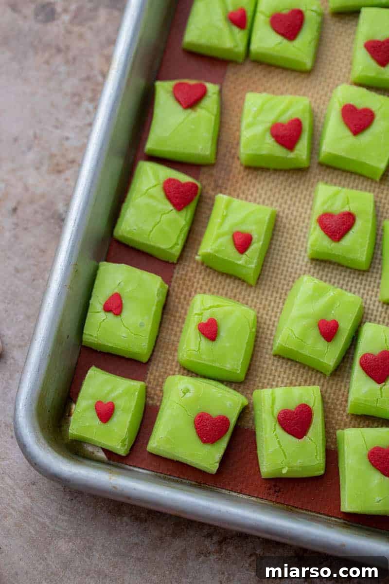Grinch's Heart-Melting Fudge 7 A block of vibrant green Grinch fudge, already sliced into perfect squares, ready for serving.