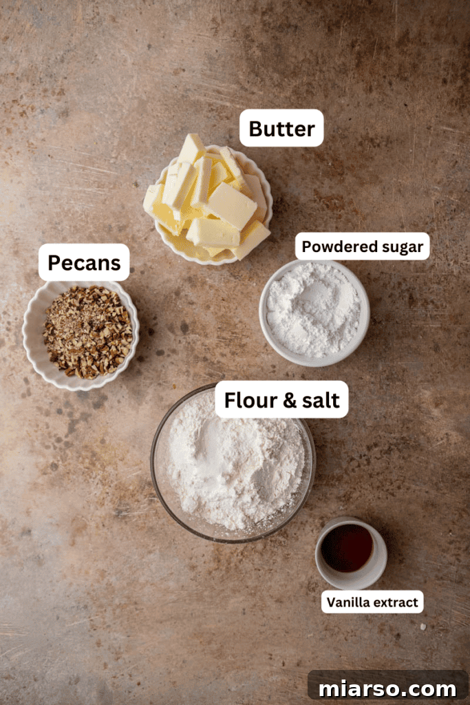 Melt-in-Your-Mouth Snowball Perfection 3 Fresh ingredients for snowball cookies, including butter, powdered sugar, flour, vanilla, pecans, and salt, laid out on a kitchen counter.