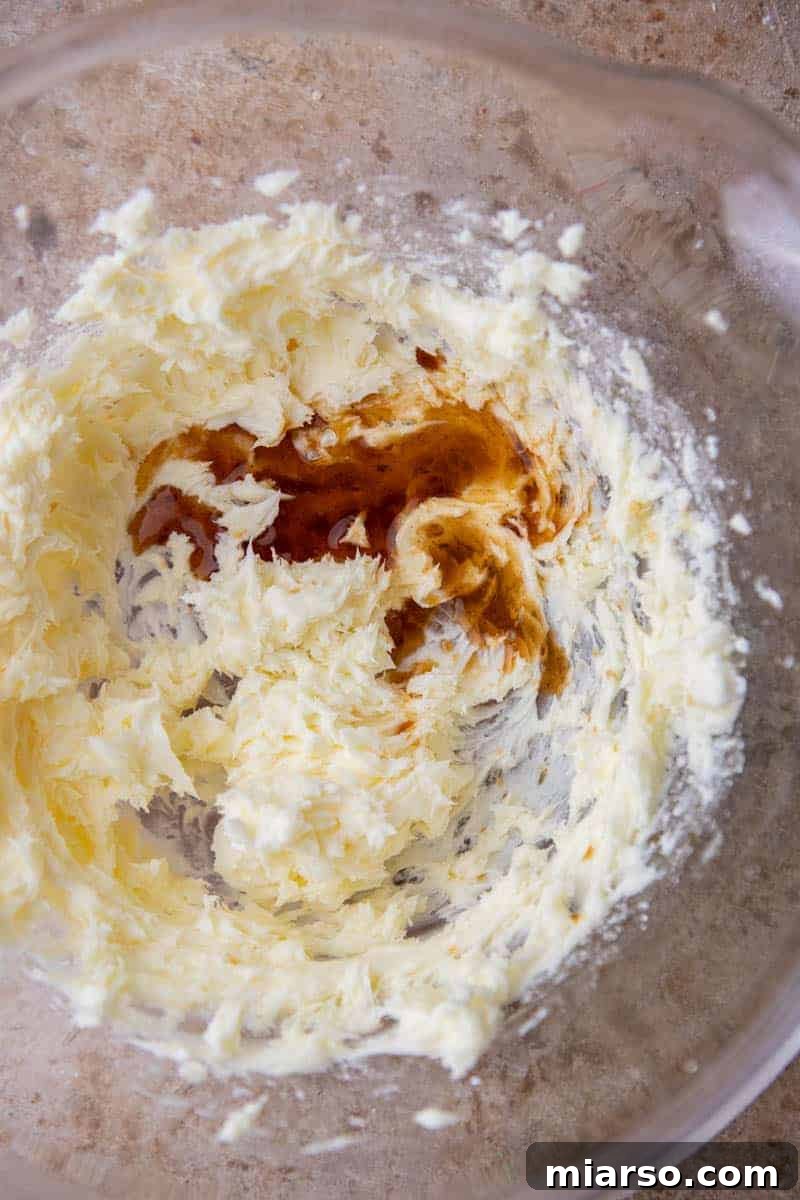Melt-in-Your-Mouth Snowball Perfection 5 Creamed butter and powdered sugar in a mixing bowl, showcasing the first step of the snowball cookie recipe.