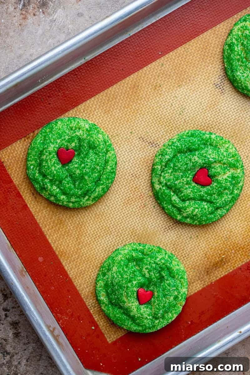 Grinch's Heart-Melting Sugar Cookies 11 Freshly baked grinch sugar cookies cooling on a baking sheet