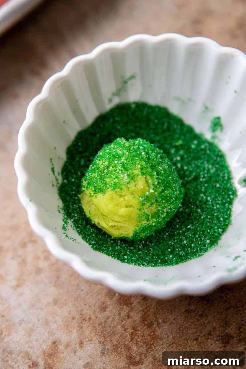 Grinch's Heart-Melting Sugar Cookies 8 Cookie dough balls rolled in green sugar, adding sparkle to Grinch cookies