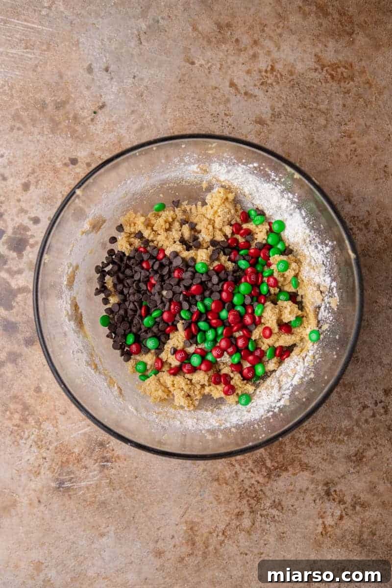 Ultimate Holiday M and M Chocolate Chip Cookies 6 Cookie dough with mix-ins in a bowl