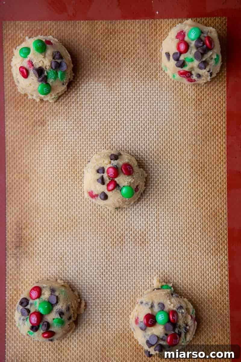 Ultimate Holiday M and M Chocolate Chip Cookies 8 Cookie dough on a baking sheet