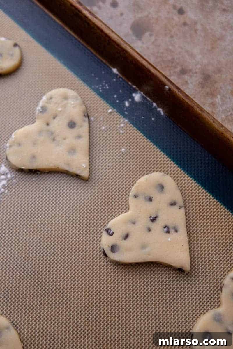 Ultimate Chocolate Chip Cut-Out Cookies 7 Chocolate chip cut out cookies on a baking sheet