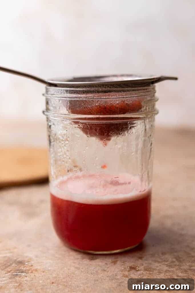 Homemade Strawberry Milk Made Easy 7 mashed strawberries in a sieve
