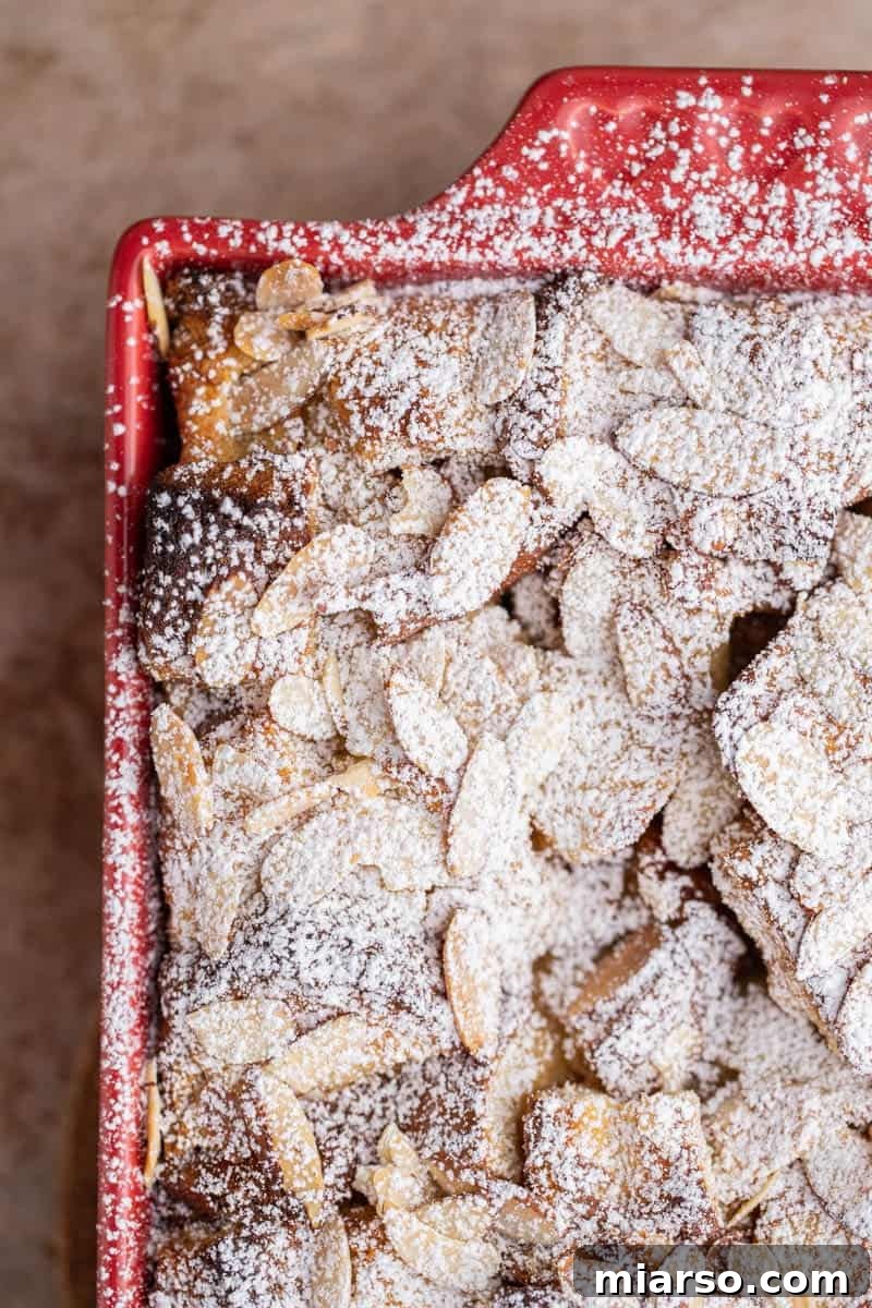 Brioche french toast casserole cooling, dusted with powdered sugar.