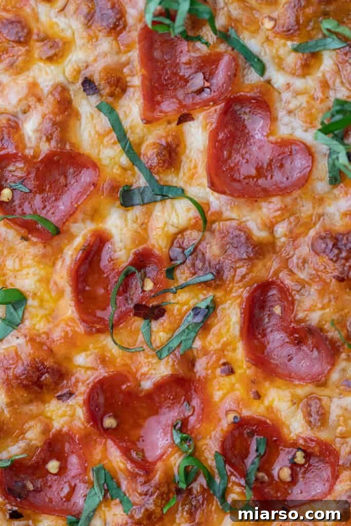 Close up of a romantic heart-shaped pizza for two, ready to be enjoyed