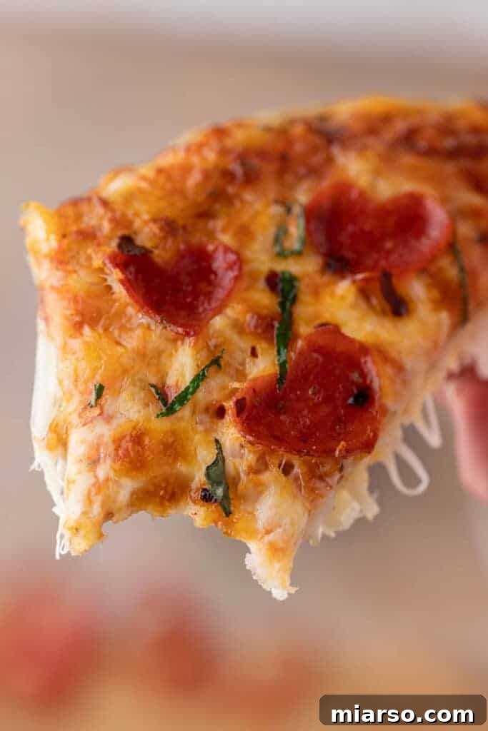 Delicious heart-shaped pizza slice with a bite taken out, perfect for Valentine's Day