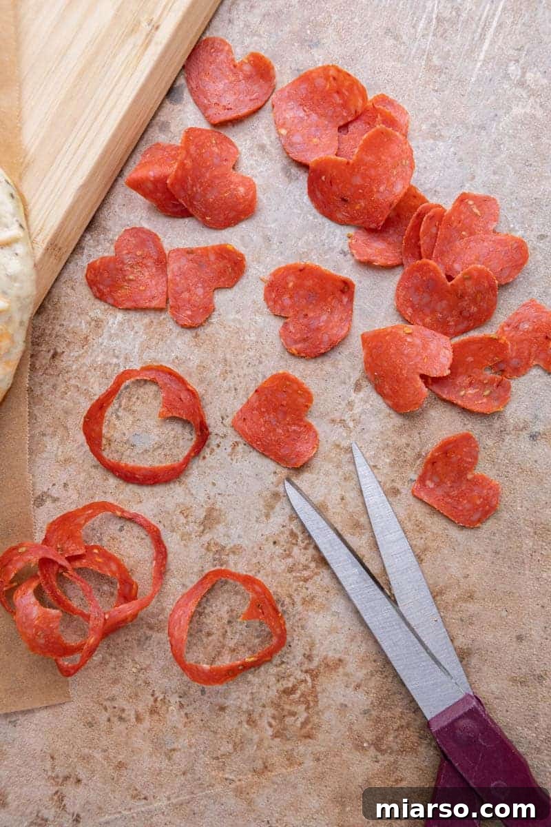 Demonstration of how to cut pepperoni into small heart shapes