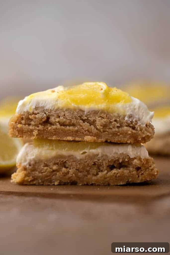 Luscious Lemon Crumbl Cheesecake Cookies 2 Close up of sliced lemon cheesecake cookies with lemon slices on top