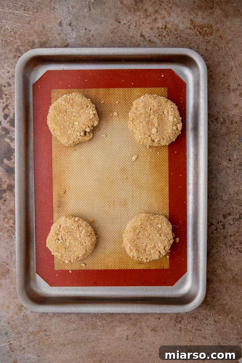 Luscious Lemon Crumbl Cheesecake Cookies 8 Freshly baked golden brown cookies on a baking sheet