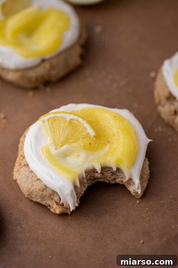 Luscious Lemon Crumbl Cheesecake Cookies 10 Crumbl lemon cheesecake cookie with a bite taken out of it showing the layers