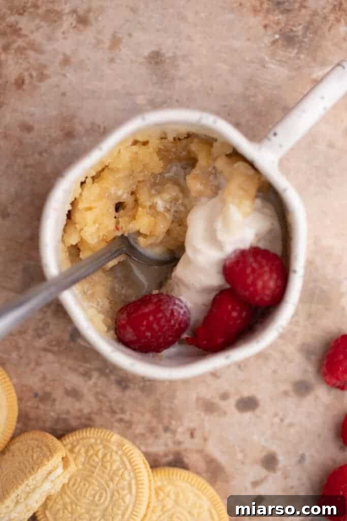 Molten Gold Oreo Mug Cake: Just 3 Ingredients 2 A warm, golden Oreo molten mug cake topped with ice cream, featuring a gooey center.