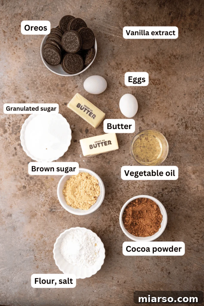 Decadent Oreo Fudge Brownies 3 Various baking ingredients including butter, sugar, flour, and cocoa powder neatly arranged on a kitchen counter, ready for making fudgy Oreo brownies.