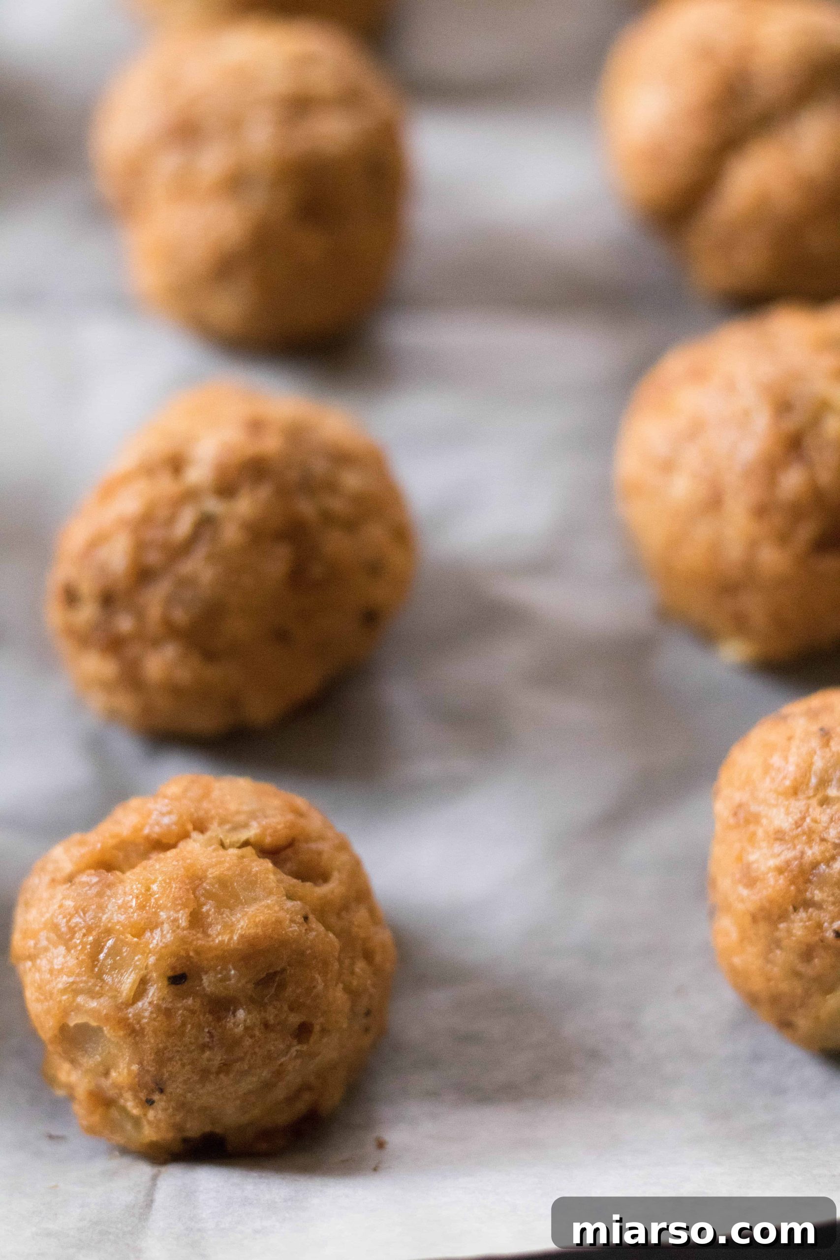Freshly baked chicken meatballs, golden brown and perfectly cooked.